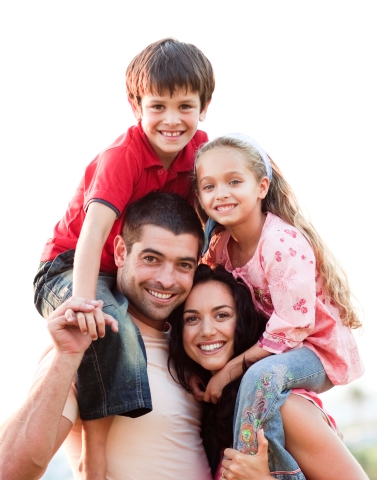 Parents giving children piggyback rides outdoors
